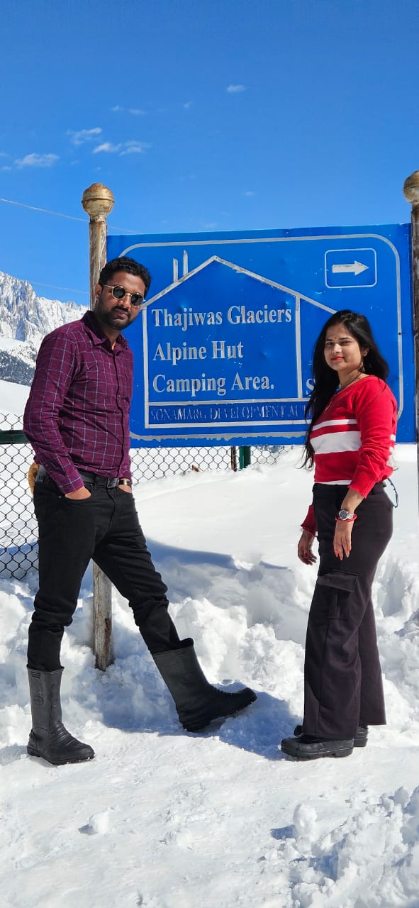 Couple at Thajiwas Glaciers sign